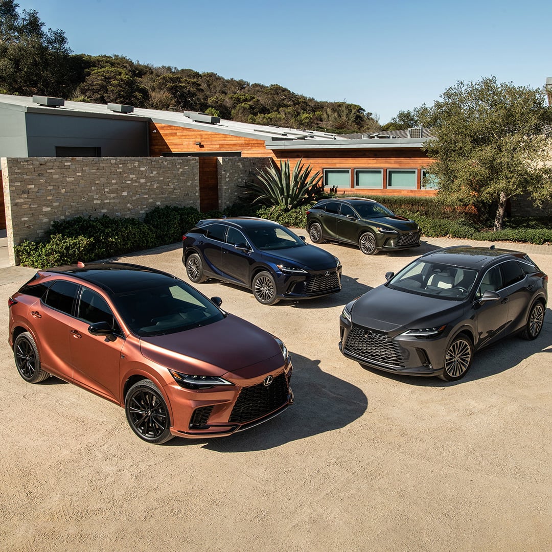 4 differently coloured and equipped RX models are parked in front of a luxury home.